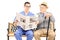 Male nurse reading newspaper to an elderly gentleman