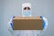 A male nurse in suit protective equipment delivers medical supplies. Coronavirus