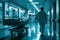 A male nurse walking beside a patient\'s bed in the brightly lit hospital hallway at night