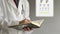 Male ophthalmologist doctor writing prescription