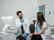 Male orthodontist with female patient looking on a screen during a medical consultation at the dental office