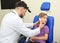 Male otolaryngologist examining little child