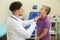 Male otolaryngologist examining little child