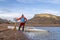 male paddler with a decked expedition canoe and a wooden paddle on a shore of Horsetooth Reservoir in northern Colorado