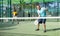 Male padel tennis player training on court