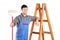 Male painter standing next to a ladder