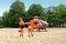 Male paramedics go to modern Red medical helicopter, emergency aircraft Germany on helipad, Air medical services, Rapid Response