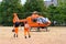 Male paramedics go to modern Red medical helicopter, emergency aircraft Germany on helipad, Air medical services, Rapid Response