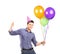 Male with party hat holding balloons and giving thumb up