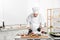 Male pastry chef preparing desserts at table