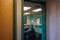 Male patient sitting alone is seen through a glass window at the entrance to a Labcorp collection facility waiting for for a