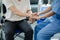 Male patient sitting in wheelchair undergoing a medical examination with specialist physician, treating injuries Getting medical