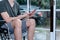 Male patients Sitting in a wheelchair, he is using a mobile phone