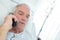 Male pensioner speaking by phone
