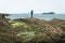 Male person stand on rugged shore enjoy seascape alone outdoors.Game of thrones filming location fishing village in Ballintoy.