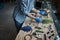 Male person in sterile gloves making herbarium in workshop