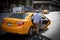 Male person taking a yellow cab