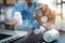 Male pharmacist holding pill with futuristic chemical formulas and research data in the foreground