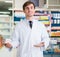 male pharmacist posing in drugstore