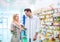 Male pharmacist serving a female customer.