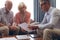 Male physician interacting with senior couple at retirement home