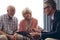 Male physician interacting with senior couple at retirement home