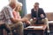 Male physician interacting with senior couple at retirement home