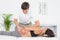 Male physiotherapist massaging womans back