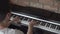 A male pianist plays a digital electronic piano at home