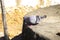 A male pigeon bird dancing on top of a wall well made of cement to attract female