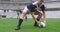 Male player passing rugby ball in the ground at stadium 4k