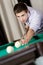 Male playing billiards at gambling club