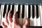 Male playing the piano keyboard. Hand close up