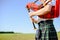 Male playing Scottish traditional pipes on green