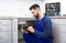 Male plumber with clipboard near kitchen sink