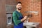 Male plumber with clipboard near kitchen sink