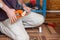 A male plumber cuts polypropylene plastic pipes with scissors to solder a water pipe