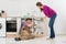 Male Plumber Repairing Pipe Under Sink In Kitchen