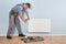 Male plumber repairing radiator