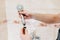 A male plumber repairs the shower head in the bathroom.