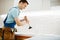 Male plumber in uniform holds plunger, clog