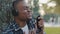 Male portrait african american young guy funny man in headphones listening to music using phone online radio pretending