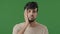 Male portrait of arabic indian disappointed guy upset stressful man stand in green studio cover face with hand outrage