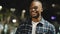 Male portrait in night city African American guy man stands in evening street looking around sad worry waiting for date