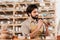 male potter in apron decorating ceramics