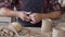 Male potter hands shaping clay in the pottery.