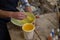 Male potters hand painting a bowl in pottery workshop