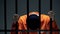 Male prisoner holding bars and leaning head, feeling depressed and guilty