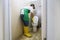 Male professional cleaner cleaning up a dirty flush toilet seat