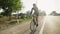 A male professional cyclist rides bicycle along the country side road